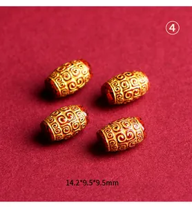Detailed close-up of cinnabar pattern barrel beads in gold finish for DIY jewelry