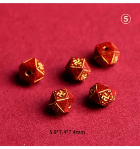 Macro view of cinnabar cinnabar red faceted beads with golden Swastika pattern for DIY jewelry