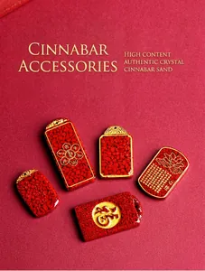 Macro shot of red cinnabar pendants with gold lotus motif and engraved Buddhist sutras