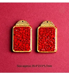 Detail view of red cinnabar pendants with gold vintage clips and precise dimensions