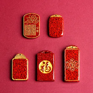 Five cinnabar amulets with gold calligraphy and heart sutra on red textured background