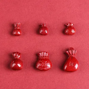 Set of cinnabar red fortune bag charms with golden shimmer for DIY jewelry making