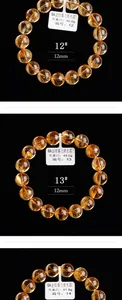 Detail van 12mm natuurlijke citrien kralenarmbanden met rutiel insluitingen op zwarte basis