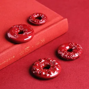 Carved cinnabar cinnabar lotus ping an kou pendant with traditional Chinese lucky patterns