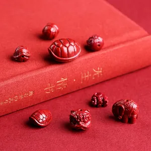 Red cinnabar bead collection featuring lion head and elephant carvings for jewelry making