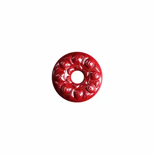Red cinnabar pendant with lotus flower carving and Chinese auspicious symbols on white background