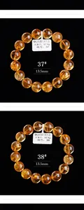 Macro-detail van twee 13,5mm natuurlijke citrien kralenarmbanden met gouden textuur