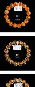Detailopname van 13mm natuurlijke citrien kristallen armbanden op zwarte achtergrond