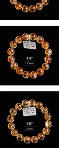 Macro-opname van natuurlijke gele citrien kristallen armband met gladde 13,5 mm kralen
