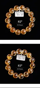 Gedetailleerde macro-opname van 15,5 mm natuurlijke citrien kralenarmbanden op zwart