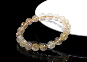 Macro detail of natural golden rutilated quartz beads with rich mineral inclusions