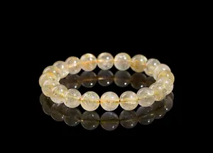 Macro detail of natural gold rutilated quartz beads with shiny golden internal needles