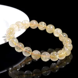 Natural gold rutilated quartz bead bracelet featuring dense golden crystal inclusions