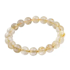 Natural golden rutilated quartz beaded bracelet with clear round crystal beads