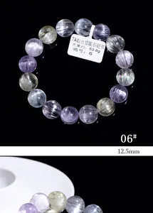 Macro shot of 12.5mm cat eye kunzite bracelet beads in purple and yellow hues