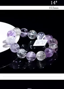Detailed close-up of 15.5mm 7A natural Kunzite beads with silk cat eye effect and tags
