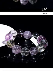 Macro shot of 19mm natural purple ghost crystal beads with clear mineral textures