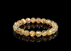 Macro shot of natural golden rutilated quartz bracelet with dense needle inclusions