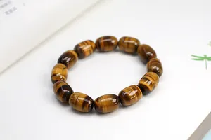 Macro shot of polished barrel-shaped tiger eye stone beads with natural chatoyant effect