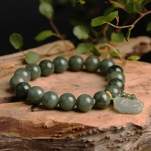 Natural Myanmar jadeite bead bracelet with green Pixiu pendant on wooden base