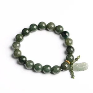 Natural green jadeite beaded bracelet with Pi Xiu pendant and gold spacers on white background