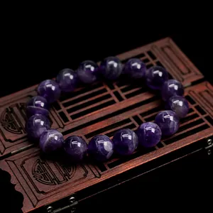 Natural dream amethyst crystal bead bracelet on antique wood box with polished texture