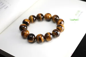 Macro view of 12mm tiger eye stone beads with natural chatoyancy and silk texture