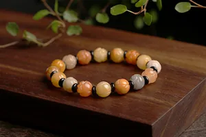 Macro detail of natural jade beads featuring lotus carving and smooth agate texture