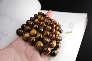 Macro view of natural tiger eye stone beads showing polished texture and chatoyancy effect
