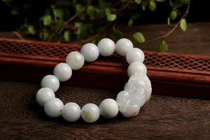 Macro detail of hand-woven natural jade Pi Xiu bracelet with smooth round beads
