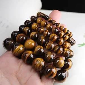 Polished natural tiger eye stone bracelets in various bead sizes showing chatoyancy effect