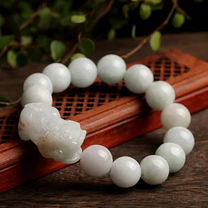Natural jade PiXiu bracelet with light green beads on a wooden base for men and women