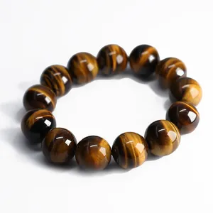 Natural tiger eye stone bead bracelet with silk sheen texture and cat eye effect on white background