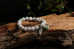 Close-up of natural jade beads bracelet with carved leaf and Pixiu charms