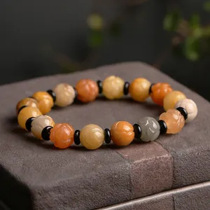 Natural gold silk jade bracelet featuring hand-carved lotus beads in earthy tones
