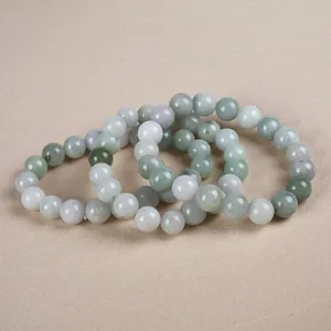 Natural jade bead bracelets in soft green and lavender tones with a polished finish