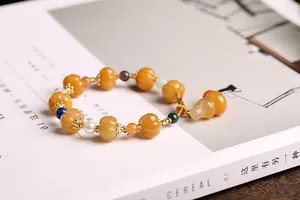 Detail of yellow pumpkin beads and colorful accents on a minimalist lifestyle background