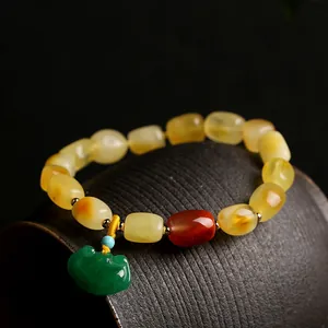 Natural amber beads bracelet with green jade Ruyi pendant and red barrel bead accent