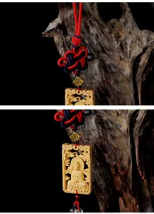 Detail view of boxwood Guanyin pendant with handcrafted red and blue Chinese knot