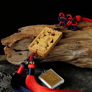 Carved boxwood Guanyin car pendant with elegant silk tassels and Zen aesthetic