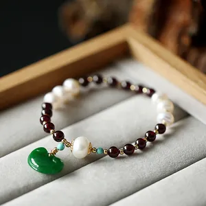 Elegant beaded bracelet with natural red garnet, white freshwater pearls and green jade