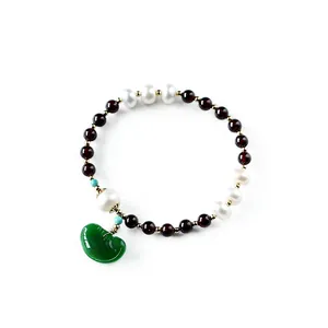Garnet and freshwater pearl beaded bracelet with a green jadeite crescent moon pendant