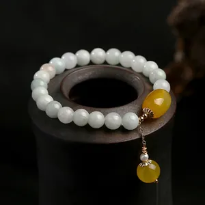 Macro shot of natural green jadeite beads with amber pendant and 14K gold-filled accents