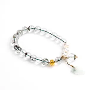 Macro detail of green phantom quartz bracelet with pearls and jade leaf pendant
