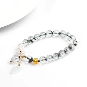 Natural Green Phantom Quartz bracelet with white pearls and gold accents on a white background