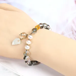 Handmade Green Phantom Bracelet with Pearls and Leaf Charm on Model Wrist