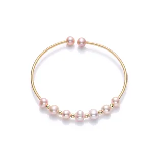 Elegant 14K gold-filled open bracelet featuring nine natural lavender freshwater pearls