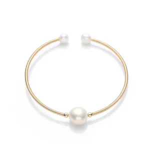 Classic 14K gold filled bangle featuring three natural freshwater pearls on a spiral band