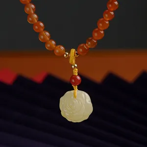 Red agate bead bracelet featuring a carved jade rose pendant and 14K gold-filled accents