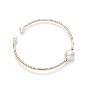 Golden stretch bracelet featuring white freshwater pearls on a spiral metal band